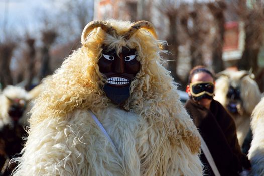 Vibrant celebration of Busójárás with locals in fur costumes and masks in Hungary.