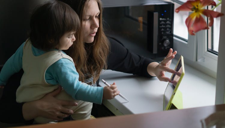 A Mother Using An IPad 