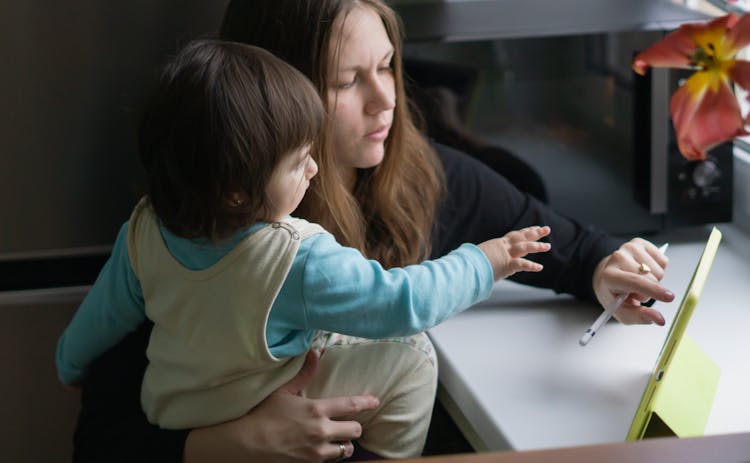 A Mother And Daughter Using An IPad