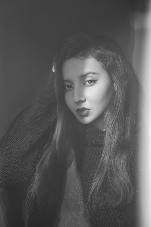 Free A dramatic black-and-white portrait capturing a woman's thoughtful expression. Stock Photo