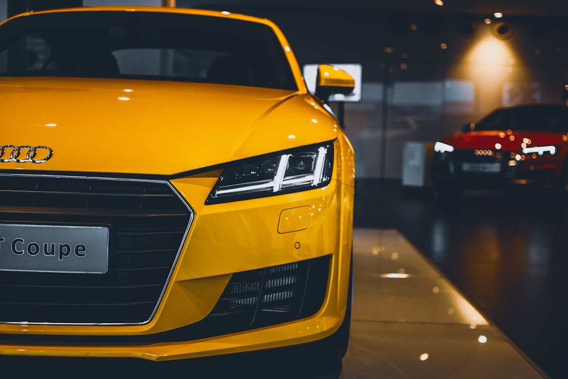 Free Shiny Yellow Audi Car in Showroom Stock Photo