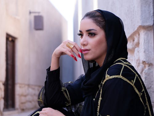 Free Closeup Photo of Woman Wearing Black Hijab Headdress Holding Her Lips Stock Photo