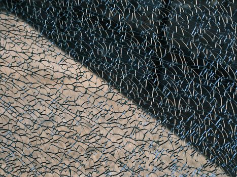 Detailed view showing the intricate patterns of cracked safety glass, highlighting unique textures.