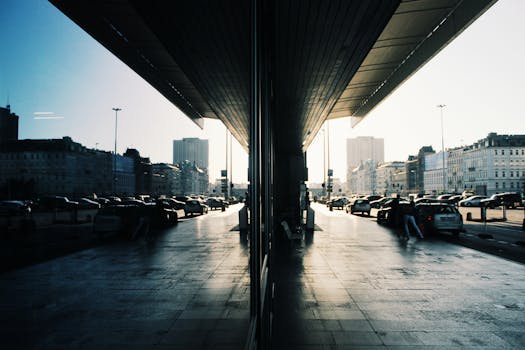 A striking reflection of Warsaw's urban landscape in daylight, showcasing traffic and modern architecture.