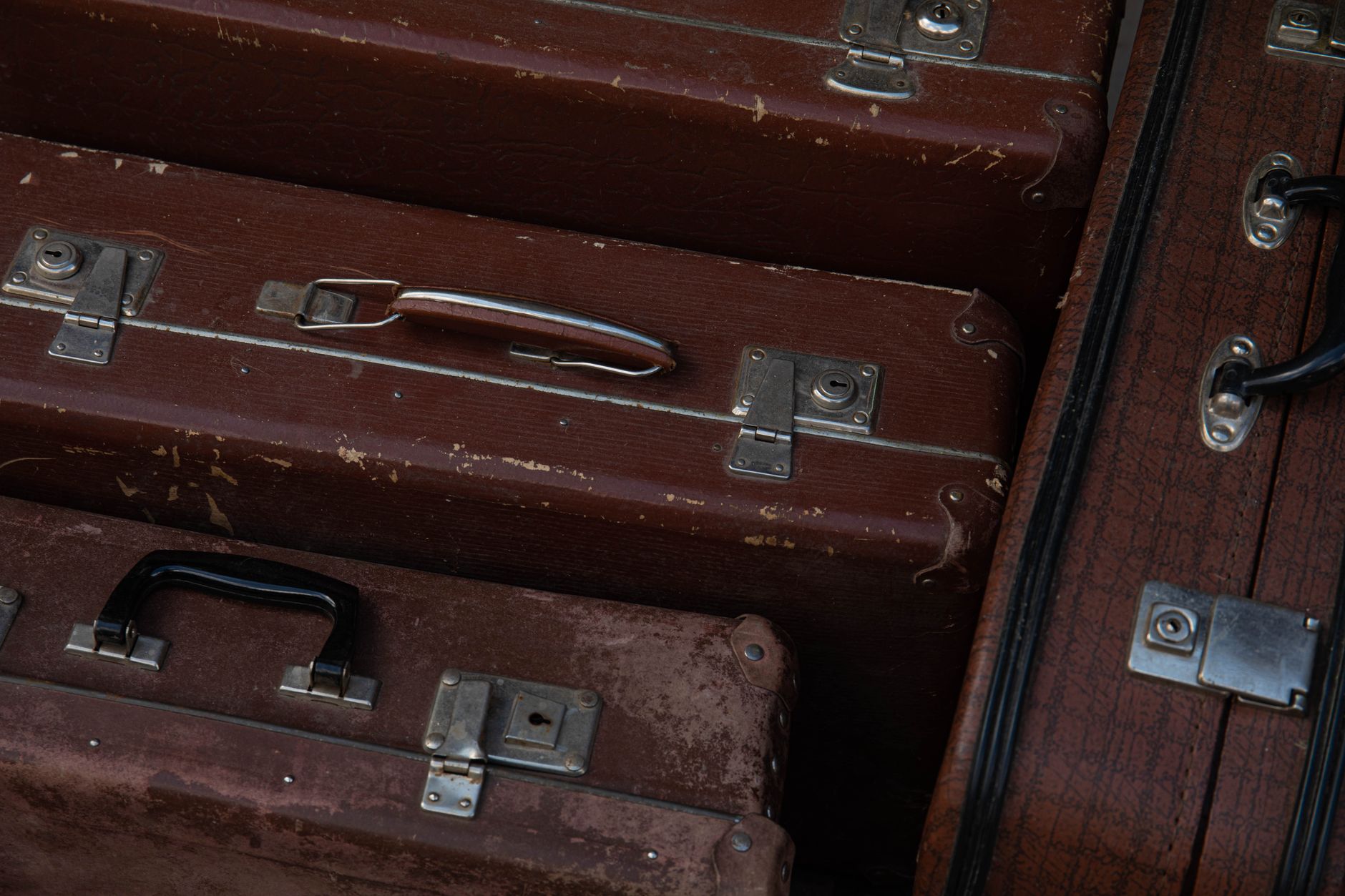 Close-up of vintage brown suitcases displaying classic design and texture.