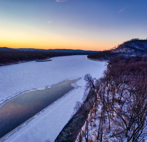 Free A stunning aerial view of a frozen river at sunset during winter in Ella, Wisconsin. Stock Photo