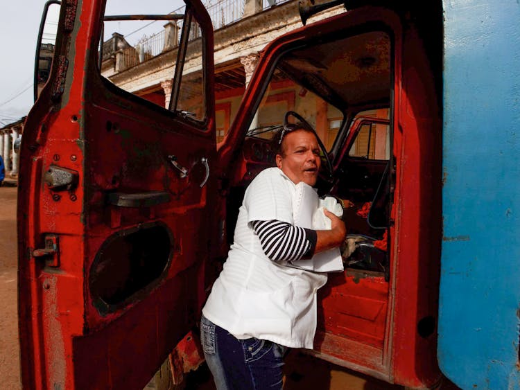 Woman Driver In Open Door Of Truck