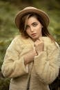 Female Fashion Model in Hat and Short Furry Coat