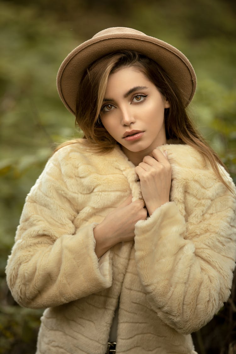 Female Fashion Model In Hat And Short Furry Coat