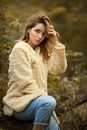 Young Woman Posing in Creamy Furry Coat and Jeans