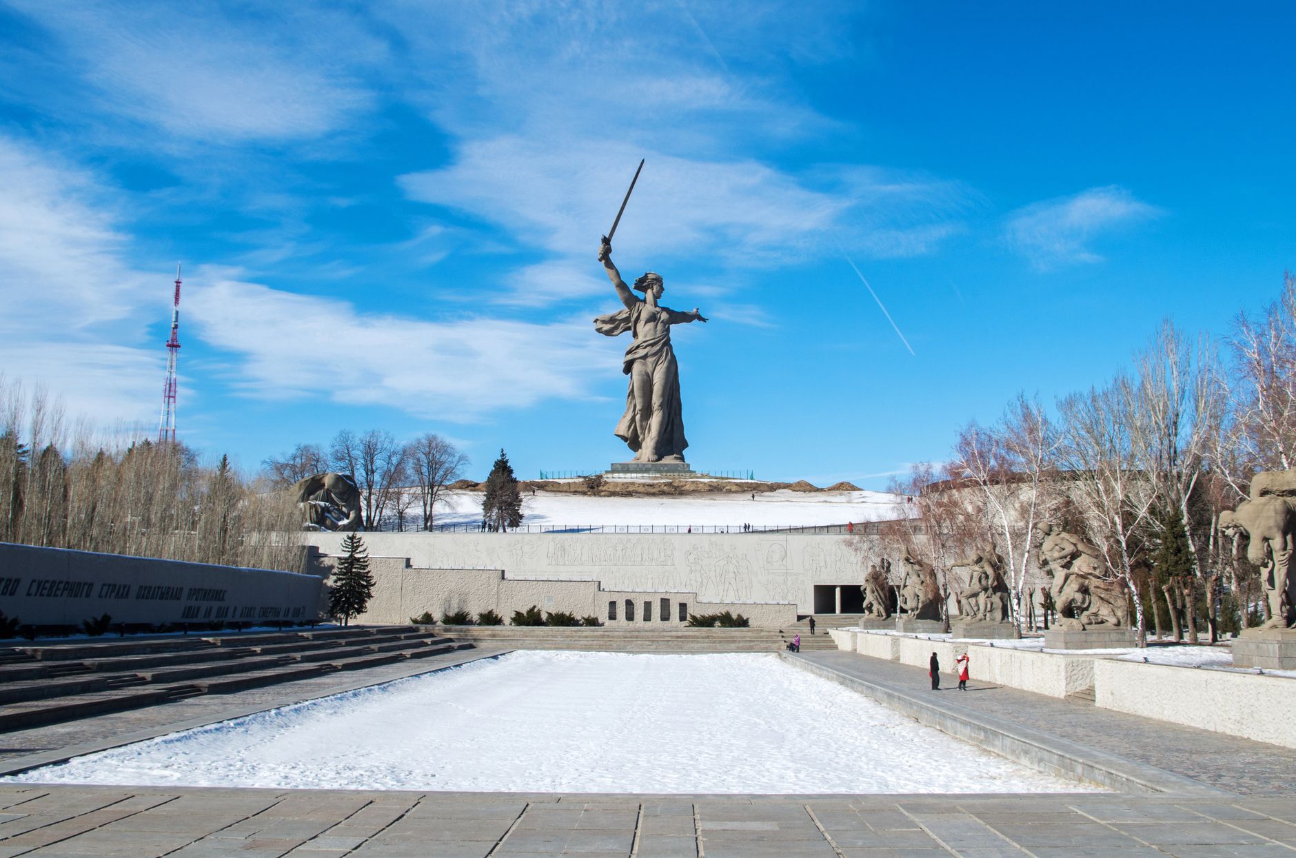 A striking view of the Motherland Calls statue in Volgograd, Russia under a clear winter sky.