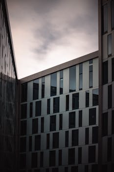 Contemporary building facade in Hamburg captured at sunset with a cool, minimalist aesthetic.