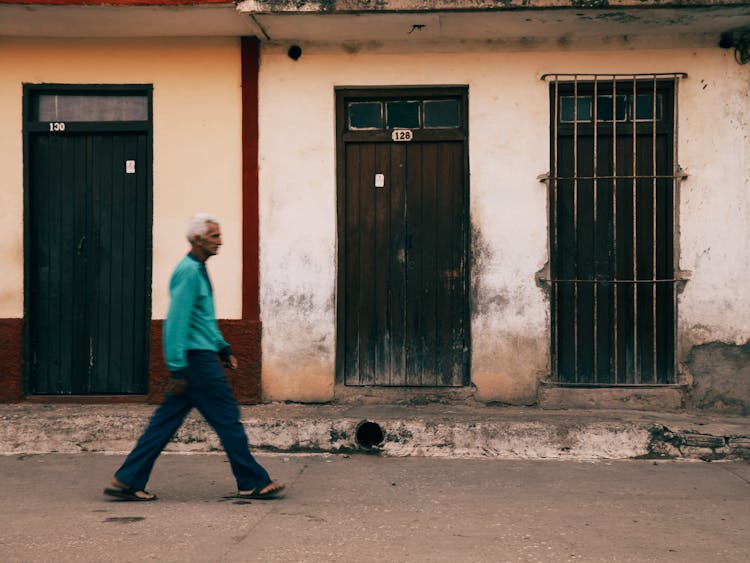 Senior Man In Blue Long Sleeve Shirt Walking On Street Sidewalk