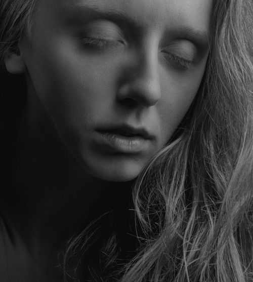 Free Artistic black and white portrait of a woman with closed eyes, capturing serenity. Stock Photo