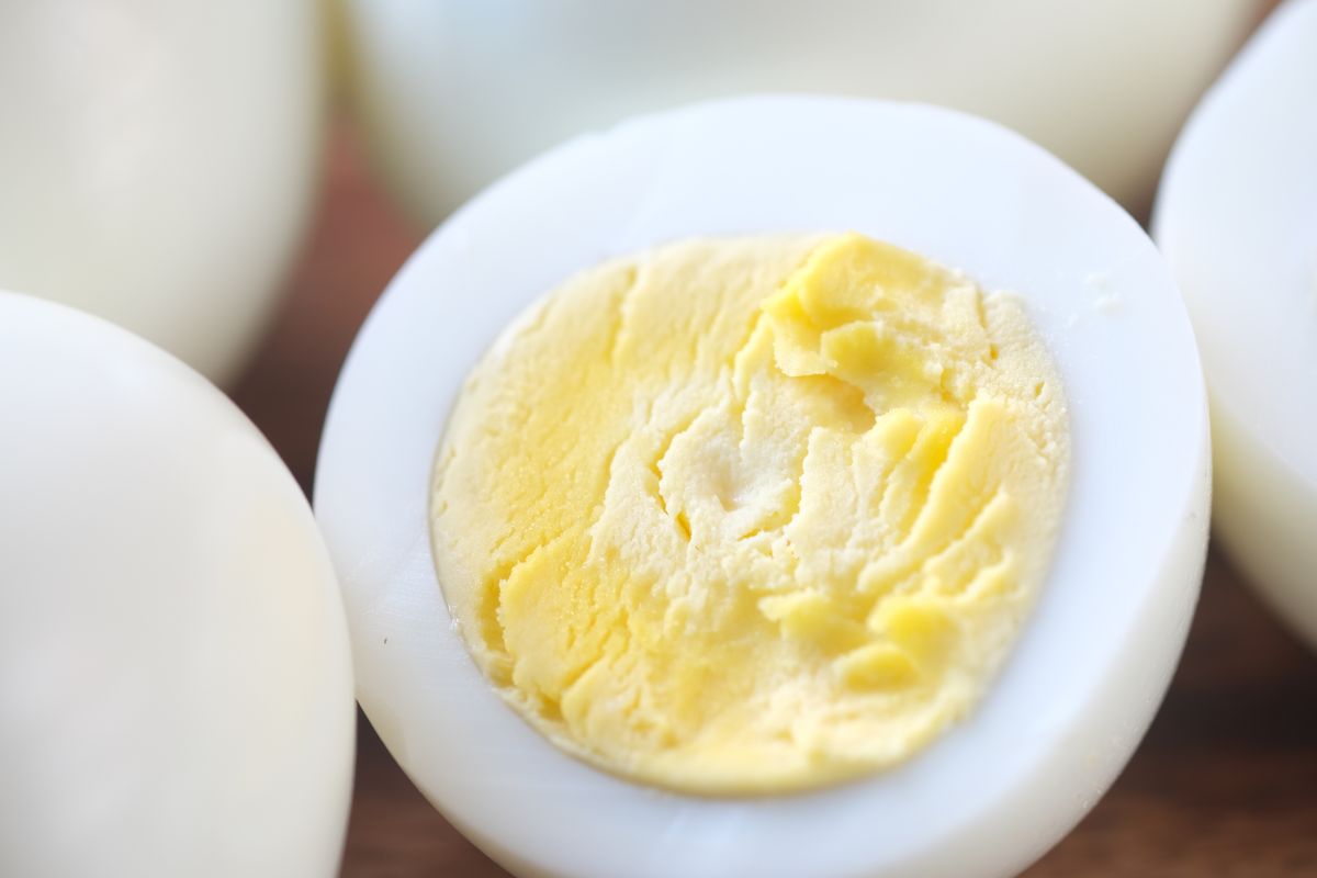 Hard-boiled egg cut in half, yolk fully set