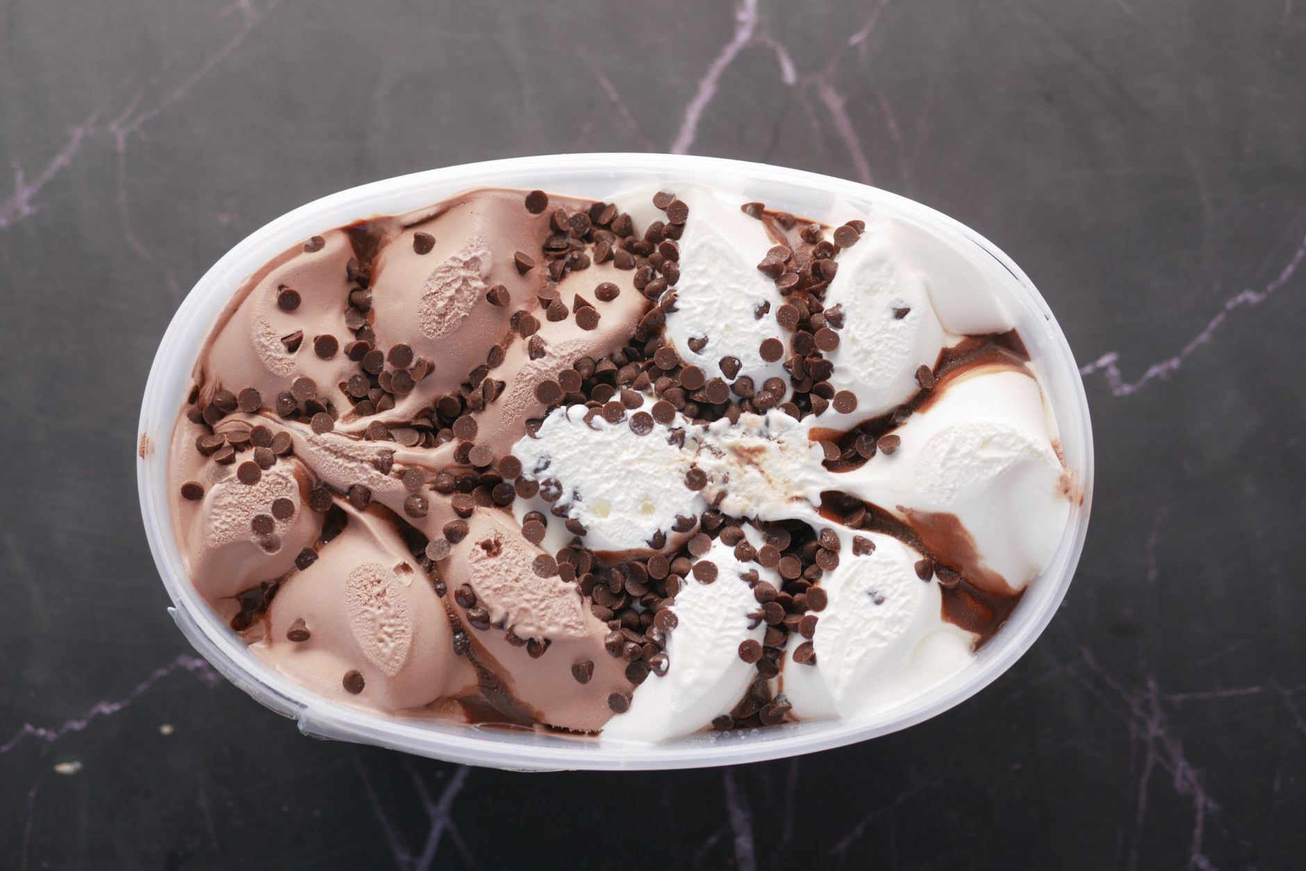 Homemade creamy ice cream scoops on wooden board