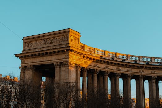 Stunning view of Kazan Cathedral's historic architecture in St. Petersburg, showcasing classical columns at sunset.