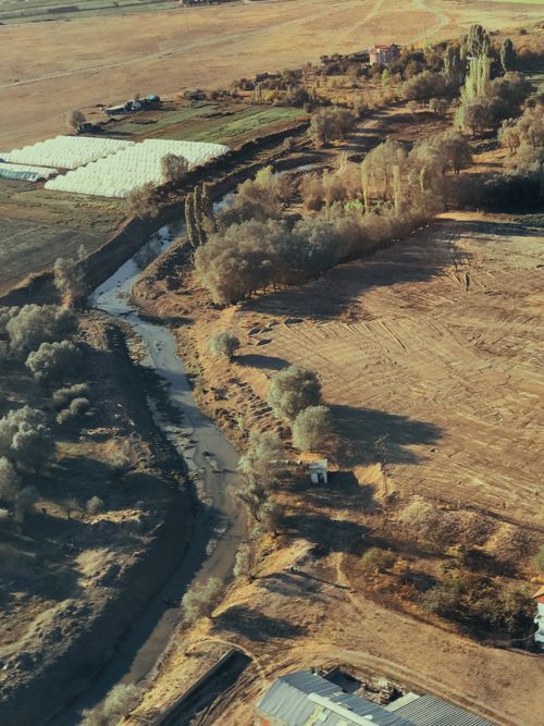 Free A picturesque aerial shot of a rural river landscape, showcasing natural beauty. Stock Photo