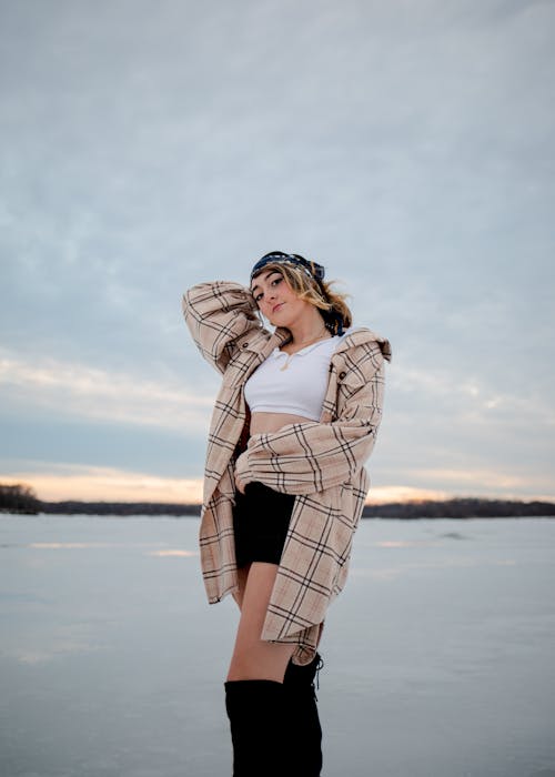 Woman in Plaid Overcoat Wearing Black Boots 