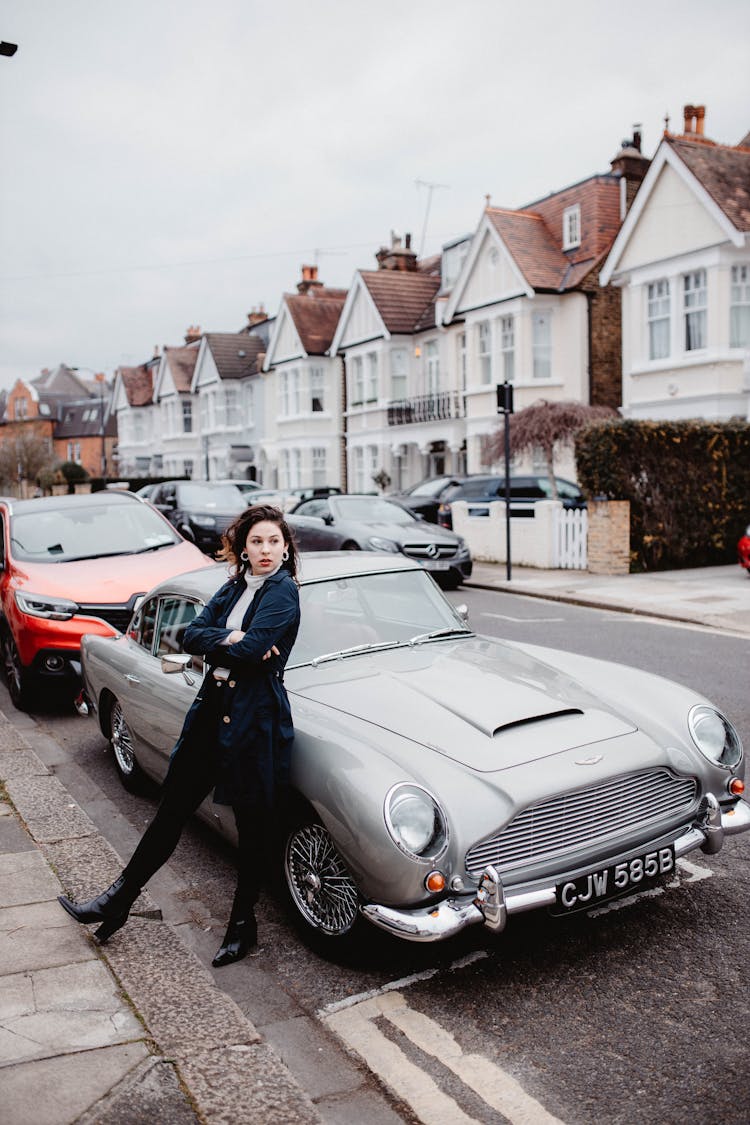 Woman Leaning On A Car Parked On The Street