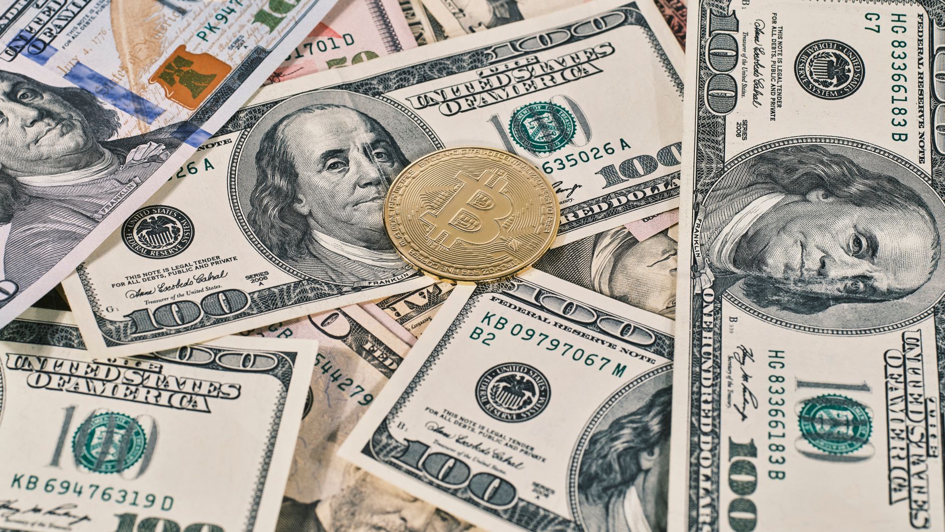 Bitcoin on US dollar bills illustrates the competition between crypto-native money and bank deposits.