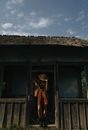 Unrecognizable Woman Leaving Old Timber Hut