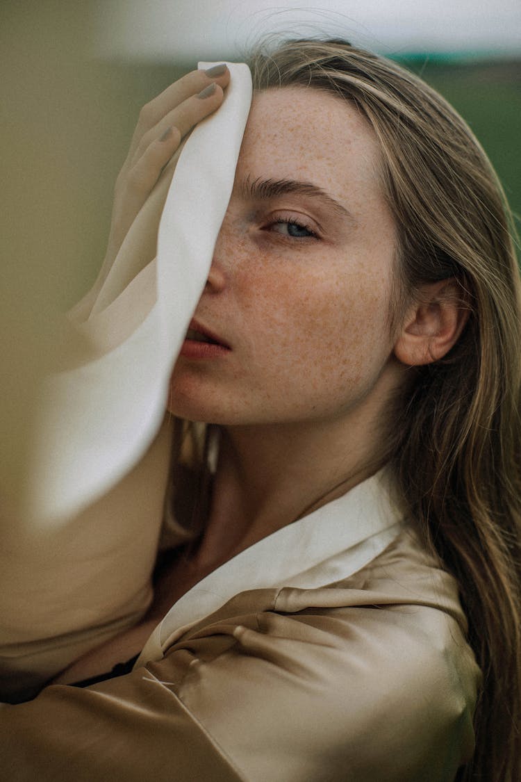 Portrait Of Young Woman Covering Face With Cloth