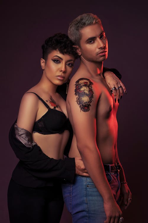 Two Shirtless Fashion Models Posing Together in a Studio