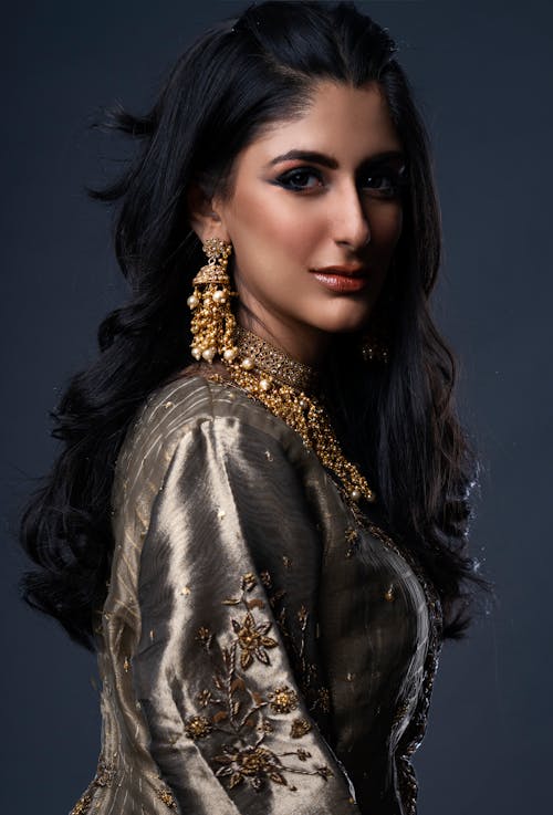 Portrait of Woman in Traditional Dress With Makeup and Gold accessories