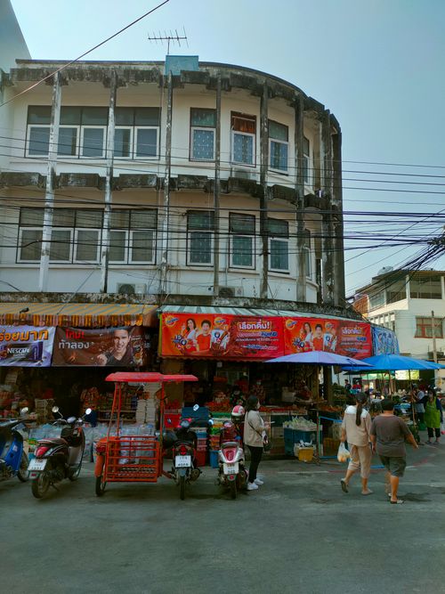 Free Bustling market street in Lampang, Thailand, with shoppers and vibrant storefronts. Stock Photo