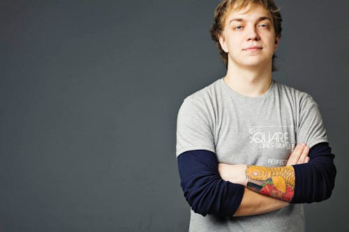 Free Man in Gray Shirt with Crossed Arms Seriously Looking at the Camera Stock Photo