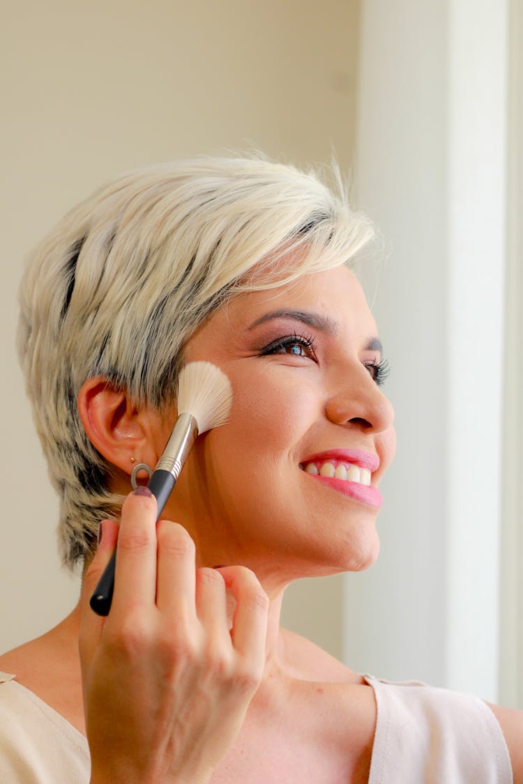 Close-Up Photo Of A Beautiful Woman Holding Makeup Brush