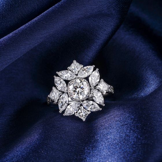 Diamond ring on blue satin, photo by The Glorious Studio on Pexels