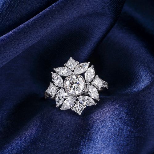 Free Stunning diamond ring displayed on rich blue satin, highlighting luxury and elegance. Stock Photo