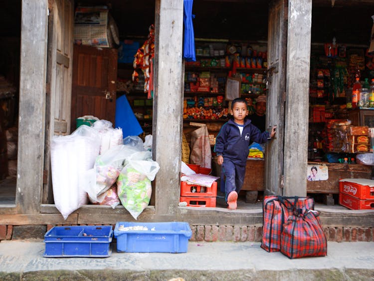 A Boy Walking Out Of A Store