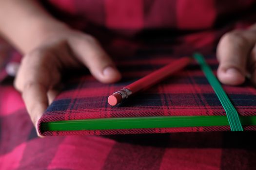 Close-Up Photo of a Pencil on Top of a Notebook