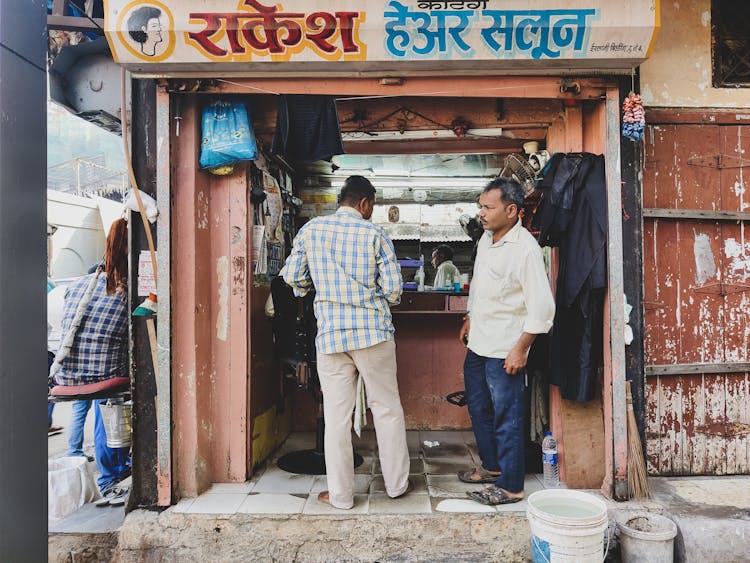 Men Standing In Front Of A Street Shop In India