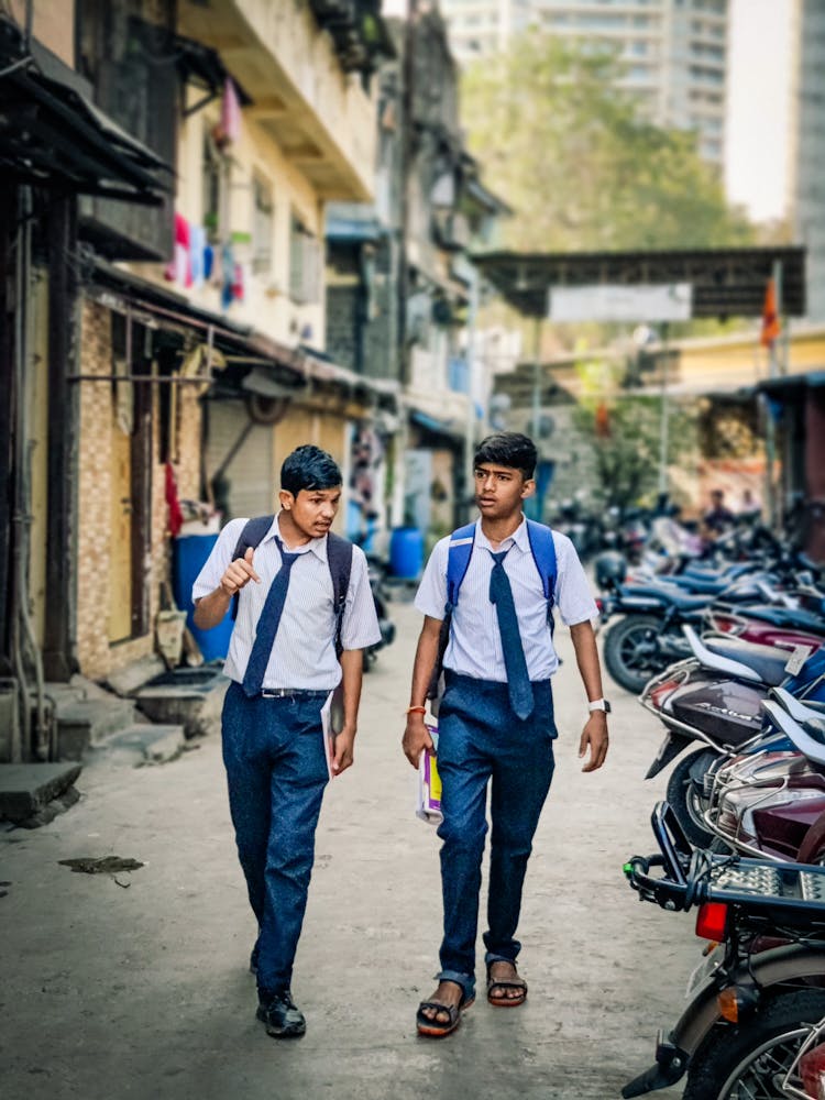 Two Young Boys Walking On The Street