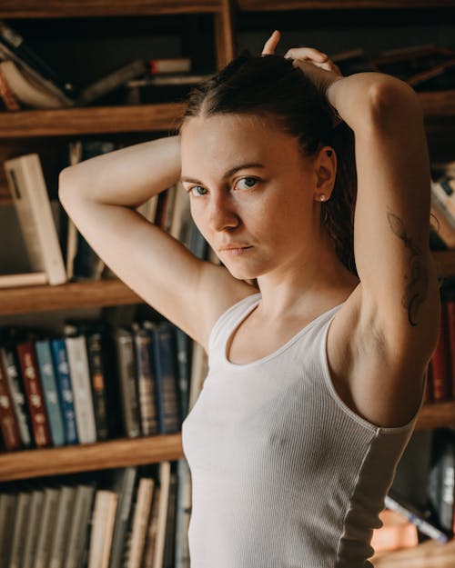 Close-Up Shot of a Woman in White Sleeveless Shirt