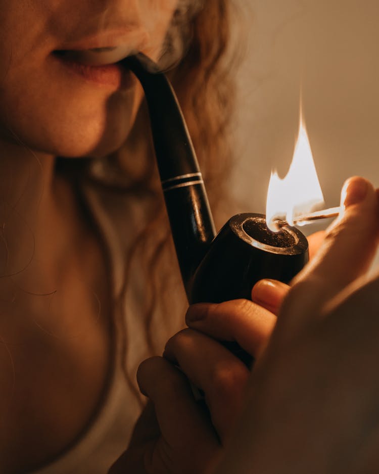 Woman Holding Black Pipe