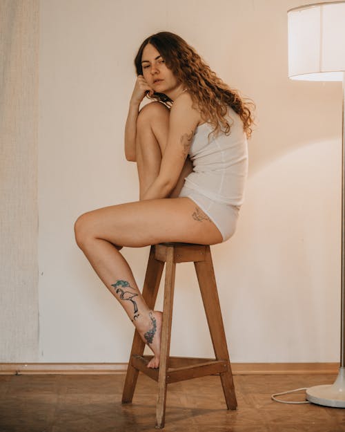 Photo of a Woman Sitting on Stool