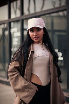 Trendy woman in Tehran wearing a cap and coat showcasing urban fashion style.