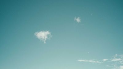 Two small clouds in a teal sky, photo by Francesco Ungaro on Pexels