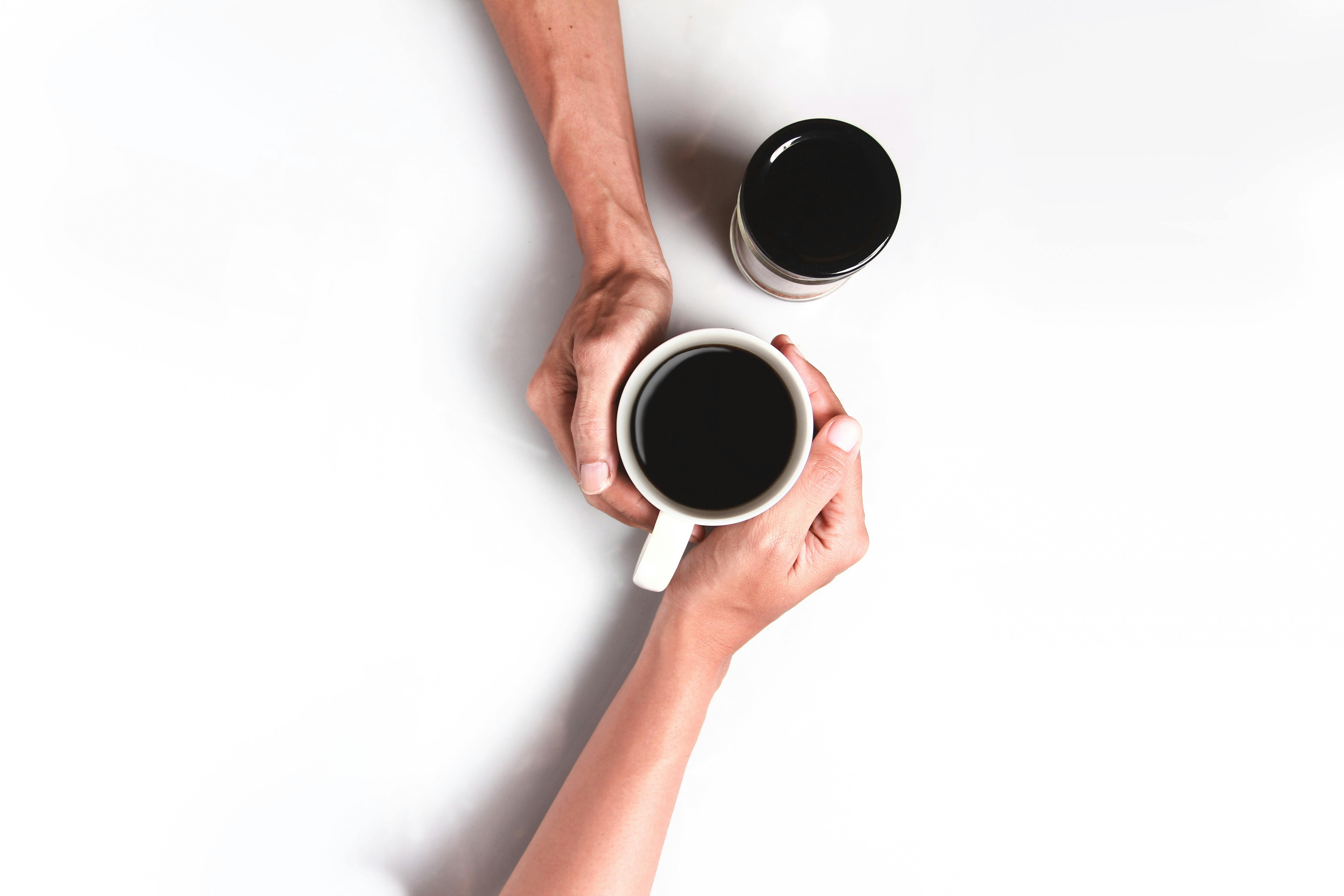 Human Hand With A Coffee Pot Serving Coffee Against White Stock Photo -  Download Image Now - iStock