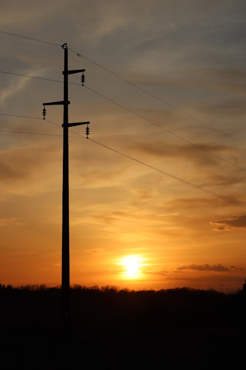 Silhouette of an Electrical Post during Sunset