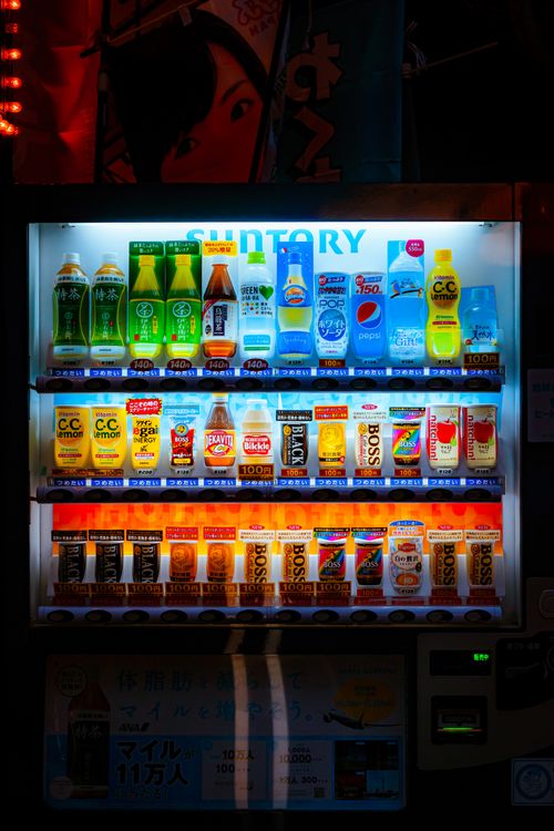 Free Vibrant, well-lit vending machine offering a variety of drinks. Stock Photo