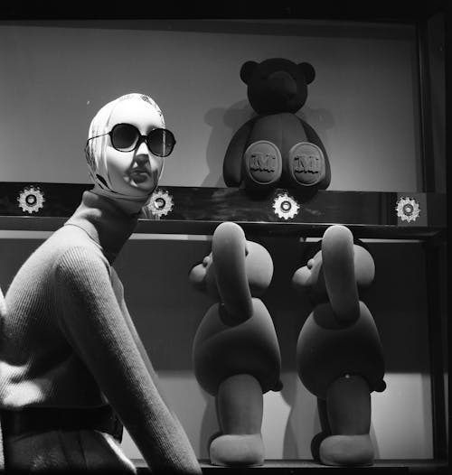 Grayscale Photo of a Mannequin and Stuff Toys
