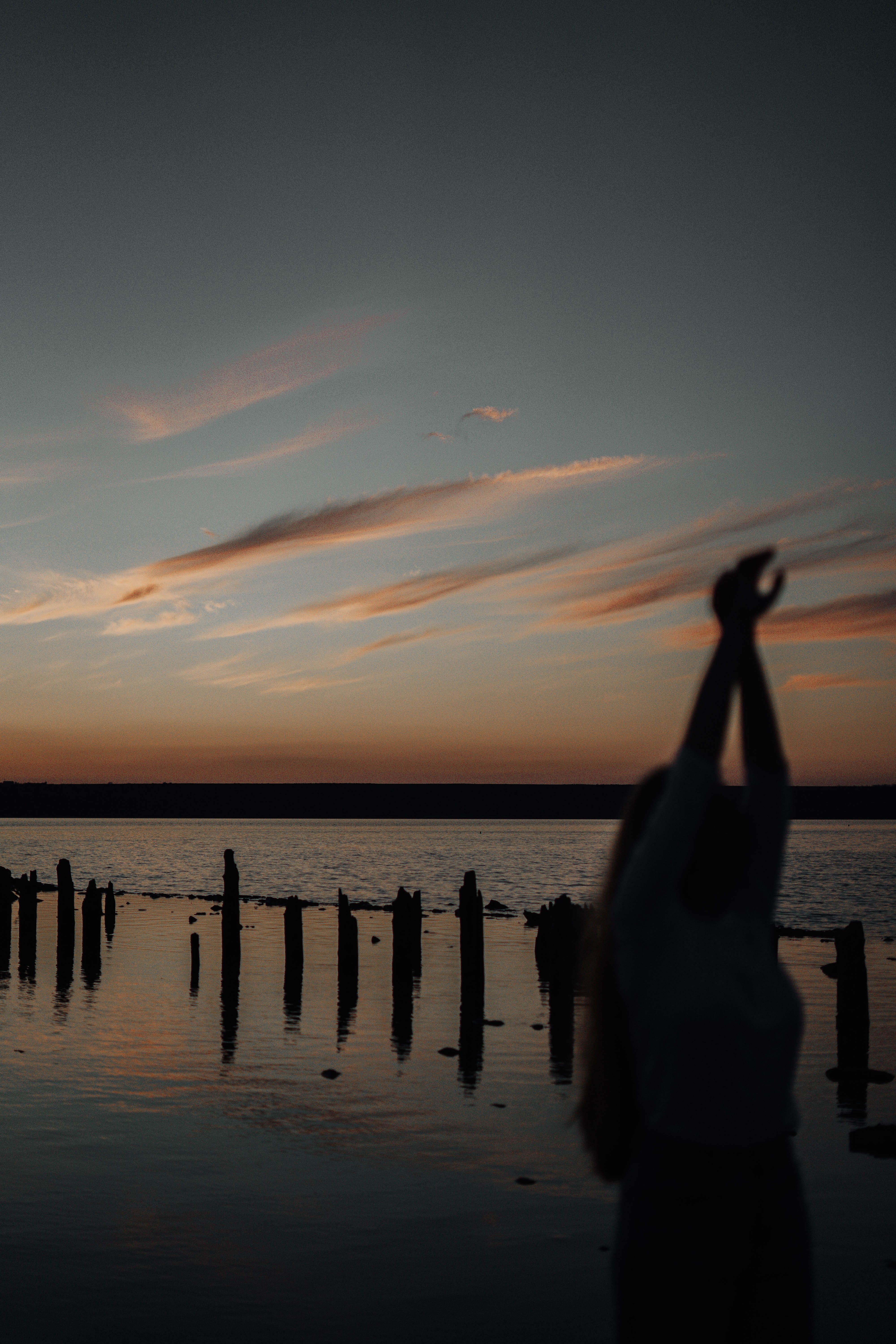 Silhouette of Woman with Sunset above Sea · Free Stock Photo