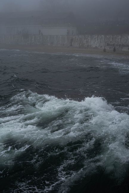 Misty view of ocean waves crashing on the Odesa shore, creating an atmospheric scene.