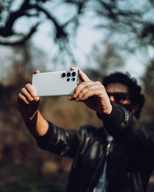 Person Taking Photo with a White Smartphone